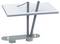 A modern table with an angled design: Grey, slanted legs support a rectangular, ribbed tabletop, in a minimalist modern style.