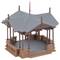 A brown model pavilion in the Victorian style with a grey roof and decorative details stands on a tiled platform.