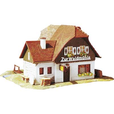 Small model building with a red roof and white walls, with the inscription 'Zur Waldmühle' on the facade.