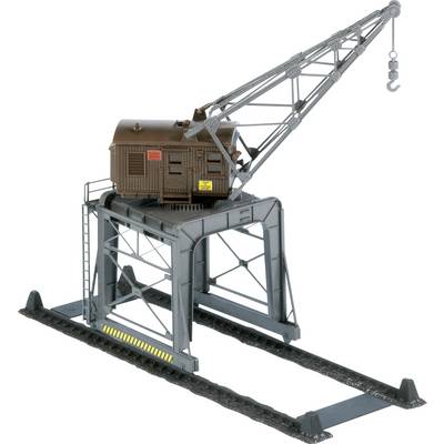 Model of a crane on rails with a brown cabin and silver arm. Suitable for model building or toy landscapes.