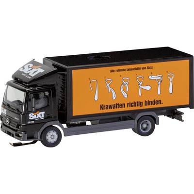 A toy lorry with the Sixt logo displays instructions for tying a tie in six steps on its side under the heading 'How to Tie a Tie Properly'.