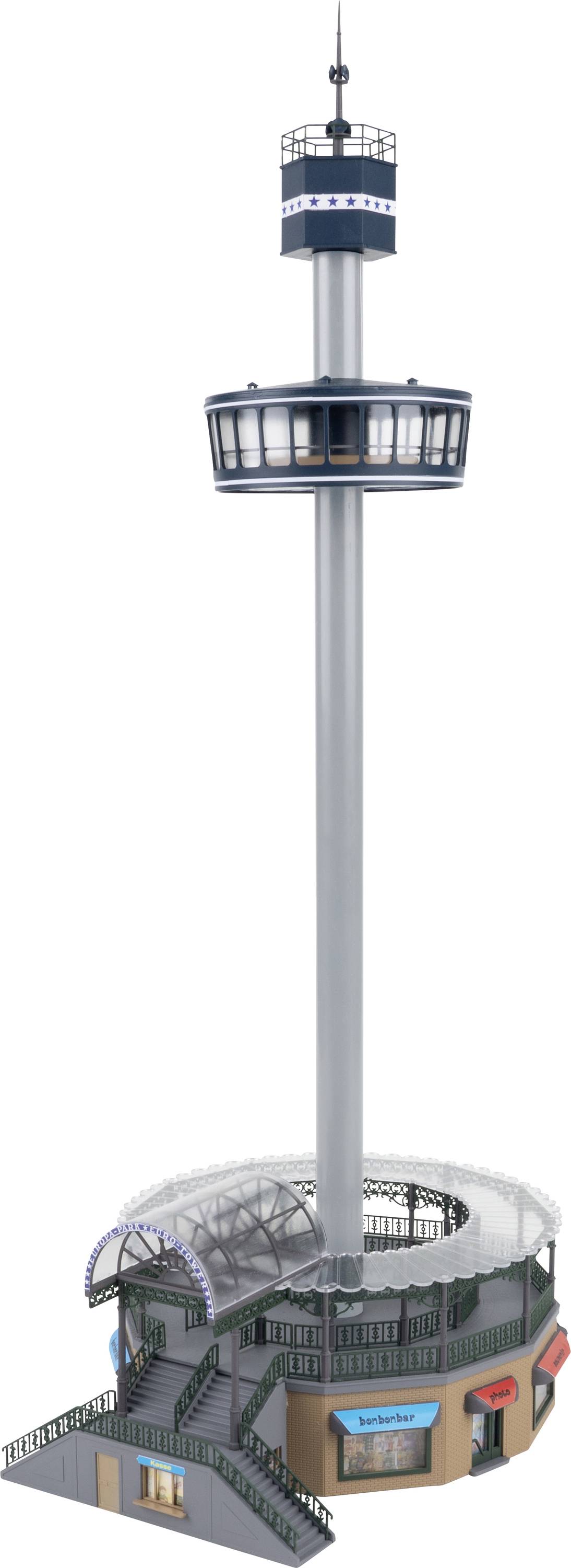 A tall observation tower with a round, glazed platform on a long pillar above a building with shops.