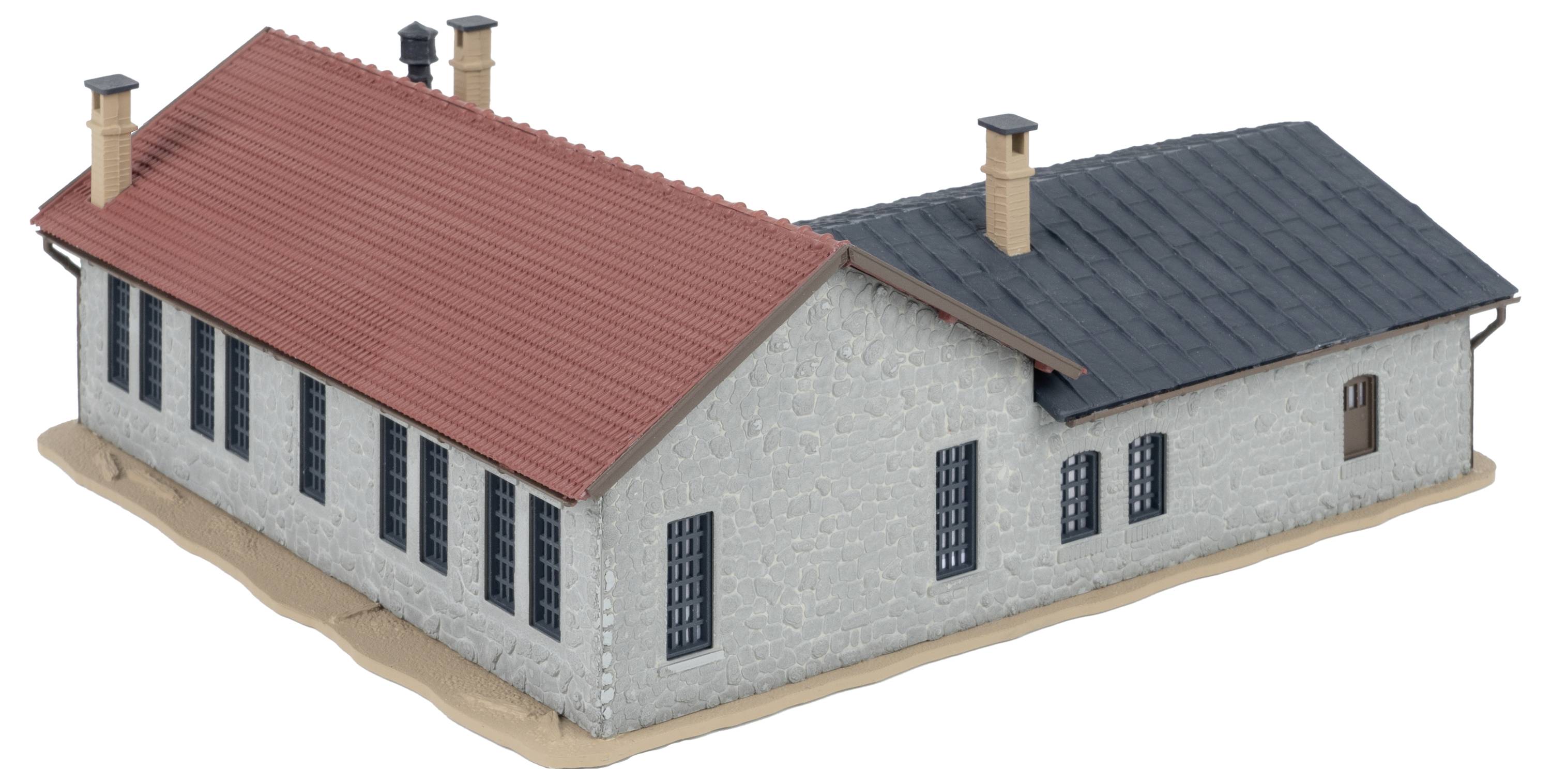 A grey model building with red and black roofs, multiple chimneys and windows. The building has an L-shaped structure.