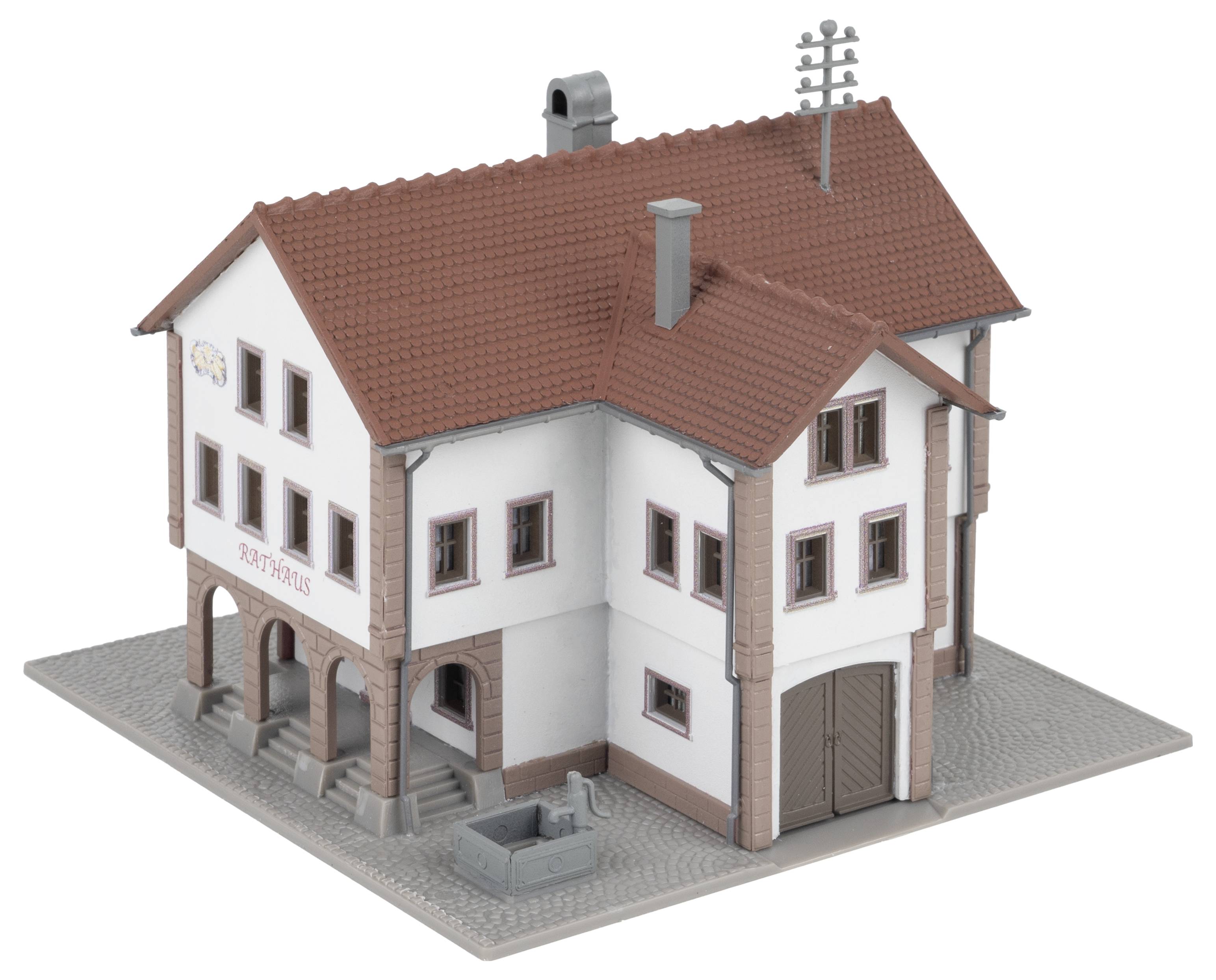 Model of a two-storey building with white render and a red roof, labelled as 'Town Hall'. Includes details such as a chimney and a fountain.