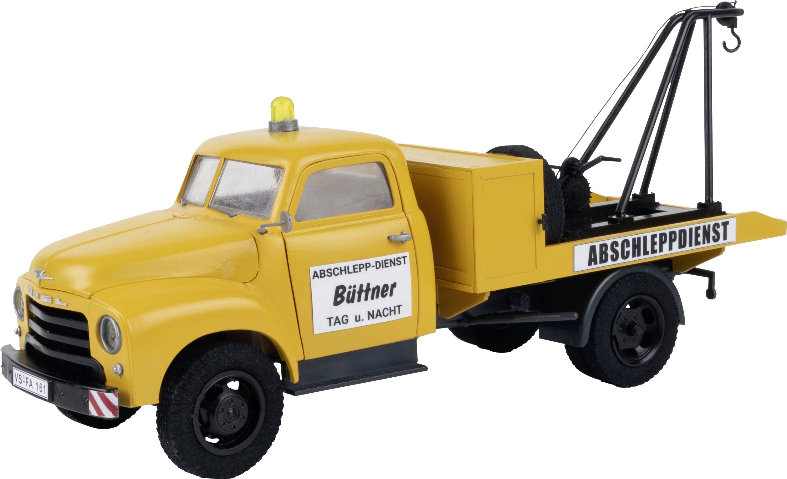 A yellow recovery vehicle with the inscription 'RECOVERY SERVICE' and 'Büttner Day and Night', equipped with a lifting mechanism.