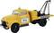 A yellow recovery vehicle with the inscription 'RECOVERY SERVICE' and 'Büttner Day and Night', equipped with a lifting mechanism.