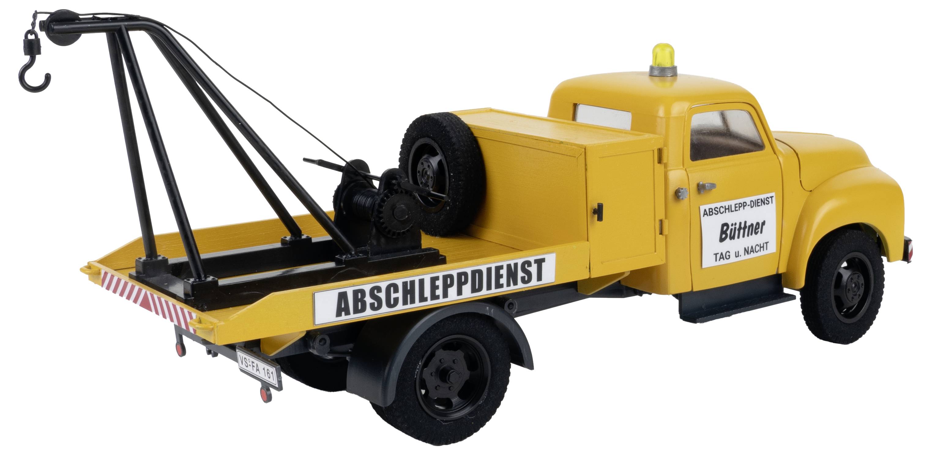 Yellow recovery vehicle model with 'Recovery Service' written on the side. Vehicle has a lifting mechanism and yellow warning light.