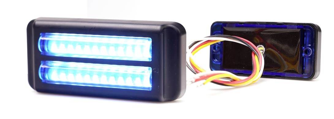 A rectangular LED light module with blue light, consisting of two strips, next to an open housing with cables.
