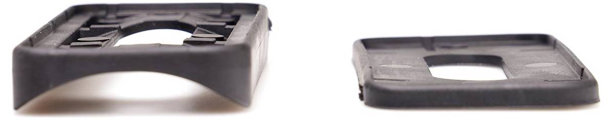 Two black plastic parts in side and top view. Both have a rectangular shape with a central recess.