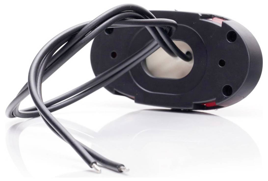 A black magnetic sensor with two connected cables lies on a glossy surface. The sensor has an oval shape.