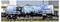 A tanker wagon on a train, painted with a large black bear on a blue background. 'MAD' text and safety markings visible.