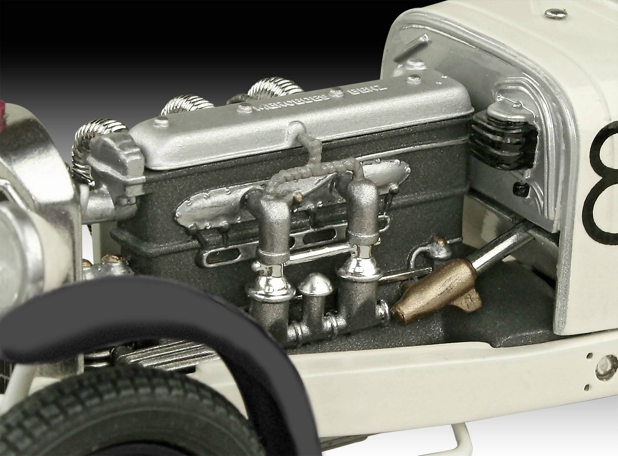 Close-up of a vintage car engine with visible six-cylinder block and exhaust. Retro industrial aesthetic.