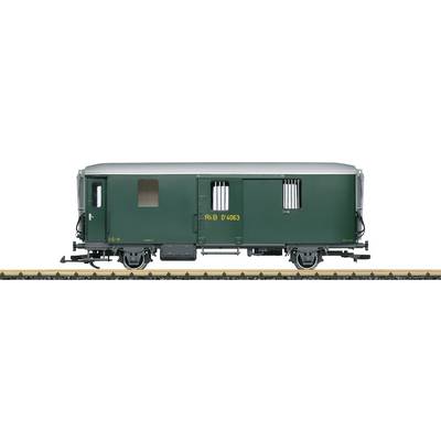 Green goods wagon on railway track, viewed from the side.