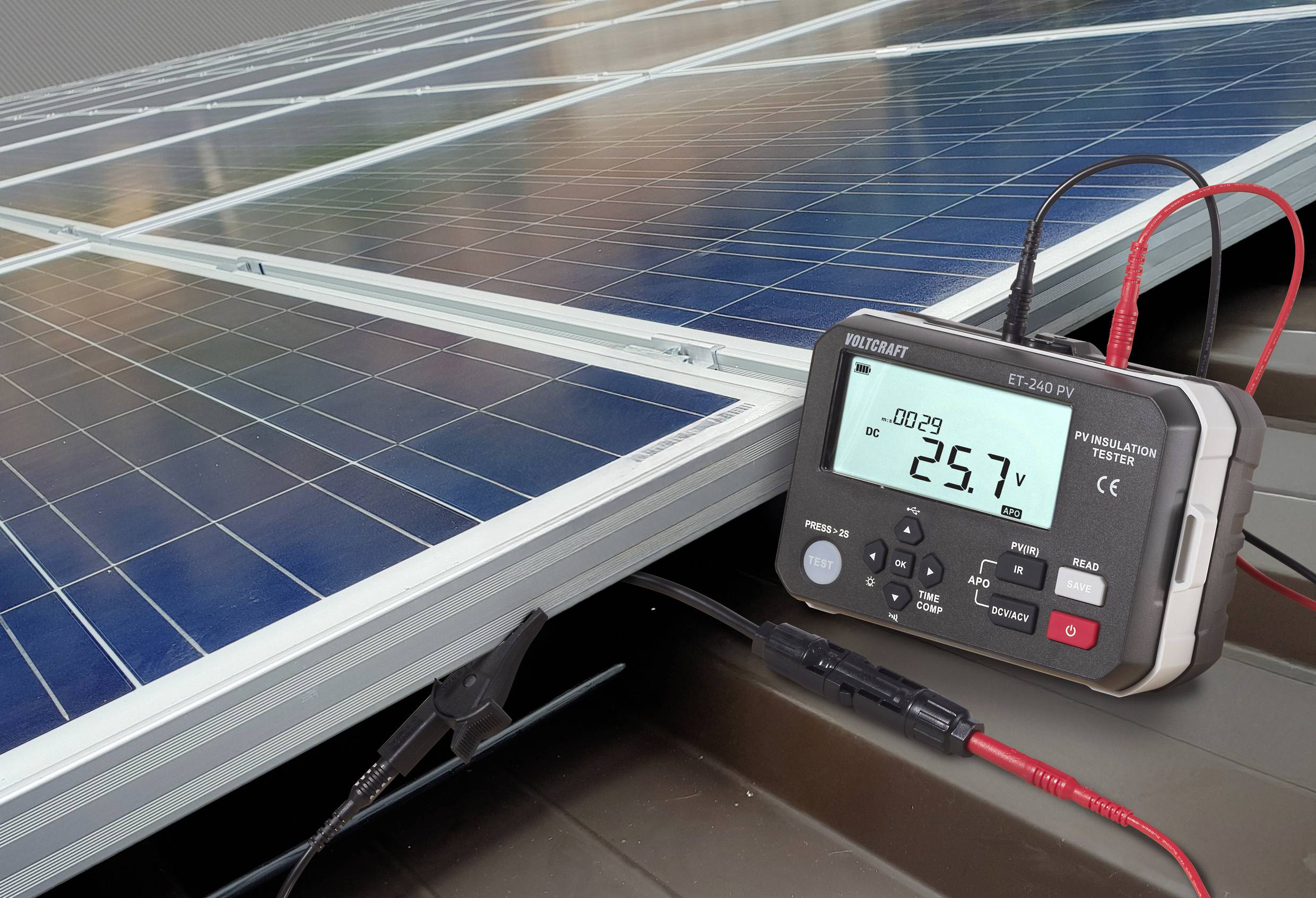 A digital multimeter displaying '25.7V' is connected to a solar panel. The setup illustrates voltage measurement in photovoltaic systems.