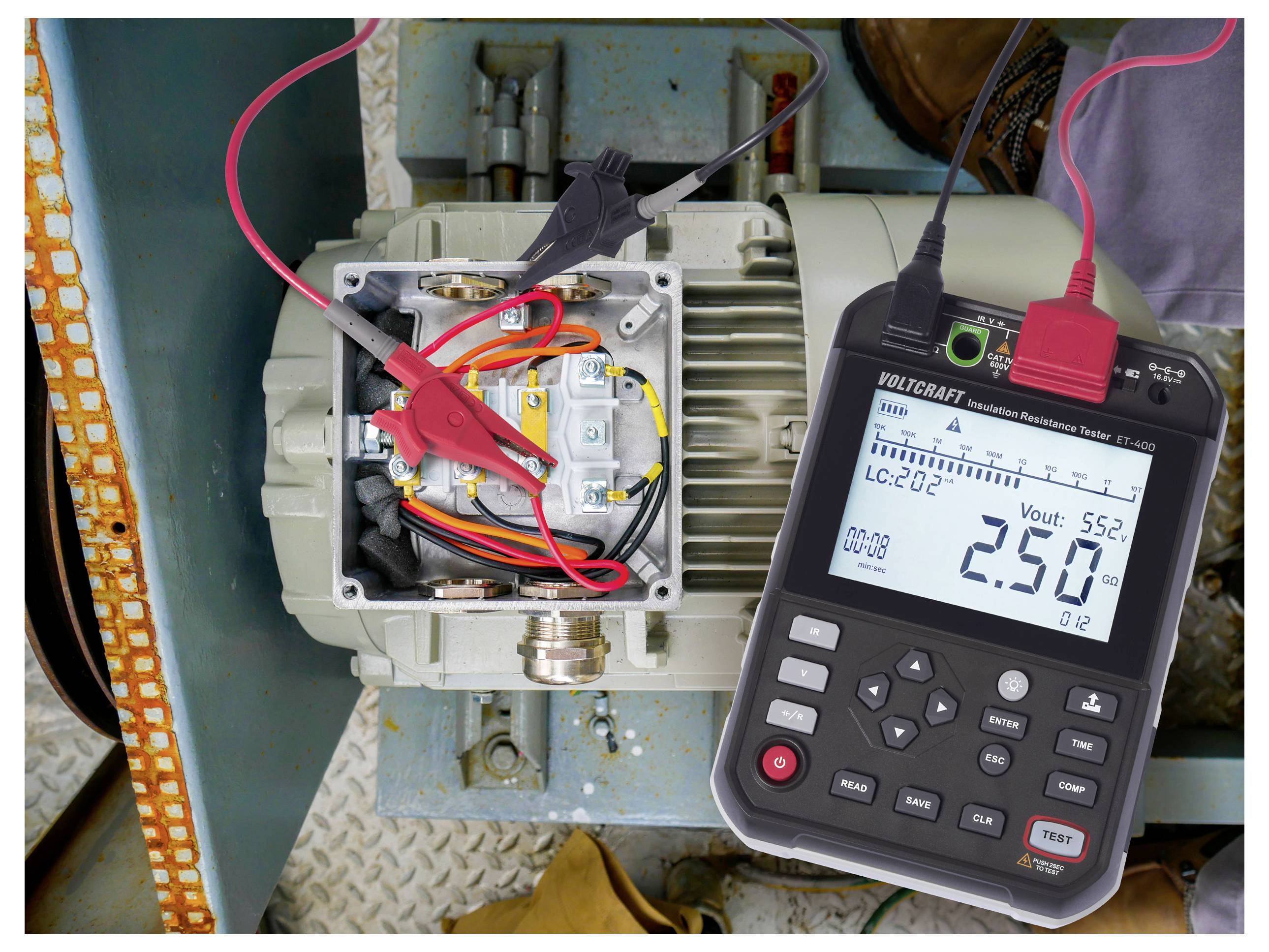 An electrical device with a digital multitester connected, displaying a voltage reading of 2.50 volts, used for equipment testing.