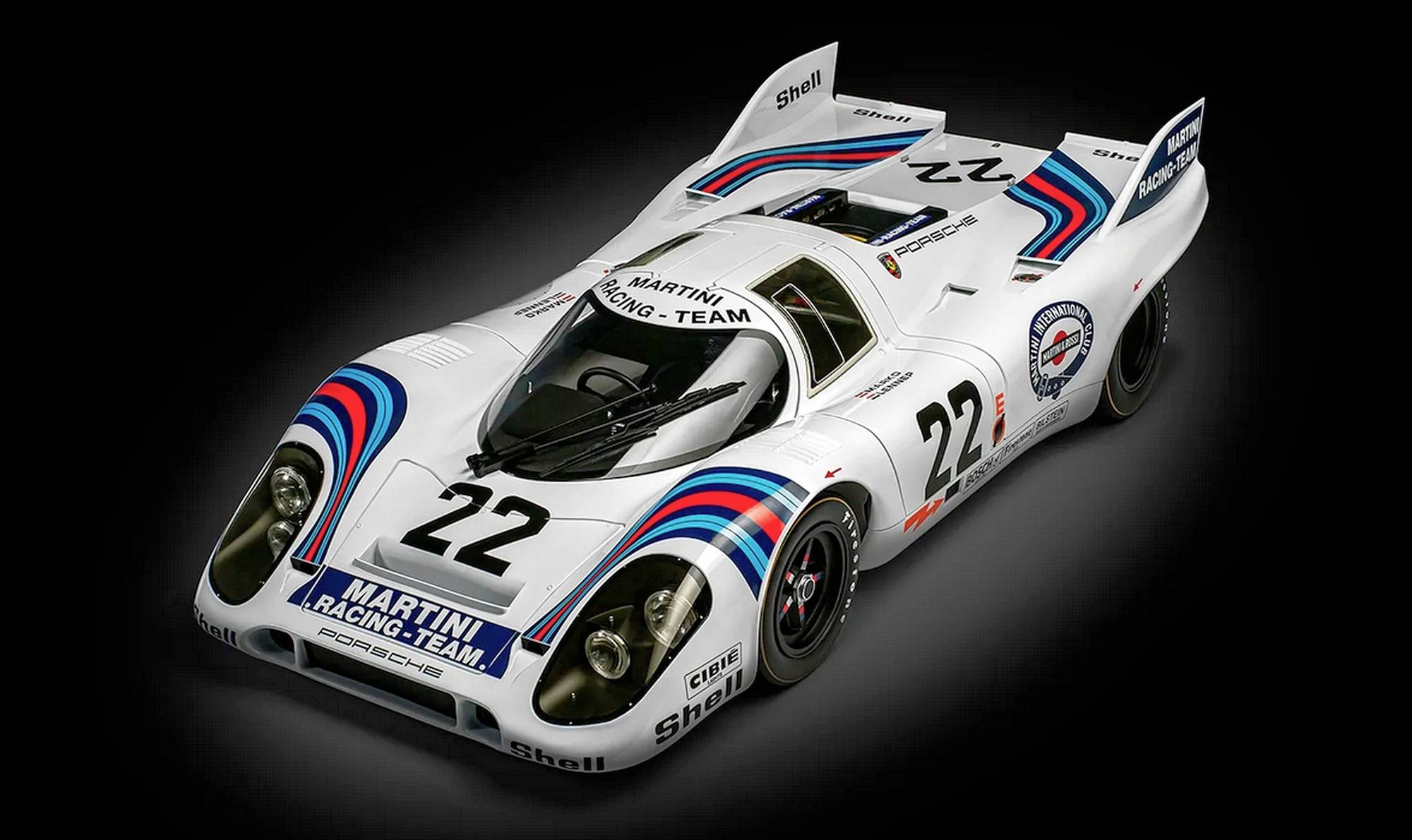 A white racing car with the number 22 and 'Martini Racing Team' lettering. It has distinctive blue and red stripes and stands against a dark background.
