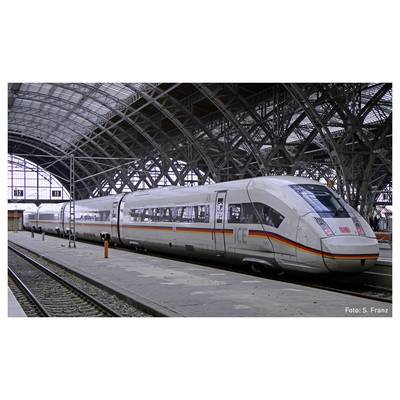 ICE high-speed train stands at the platform in a covered railway station. The vehicle is white with red and yellow stripes.