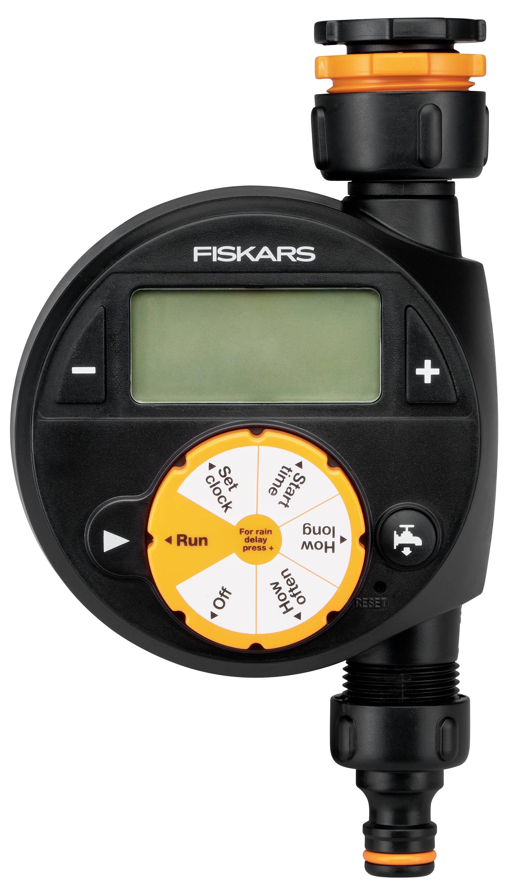 A Fiskars irrigation timer with a display and control buttons. It is mounted between a tap and a hosepipe.