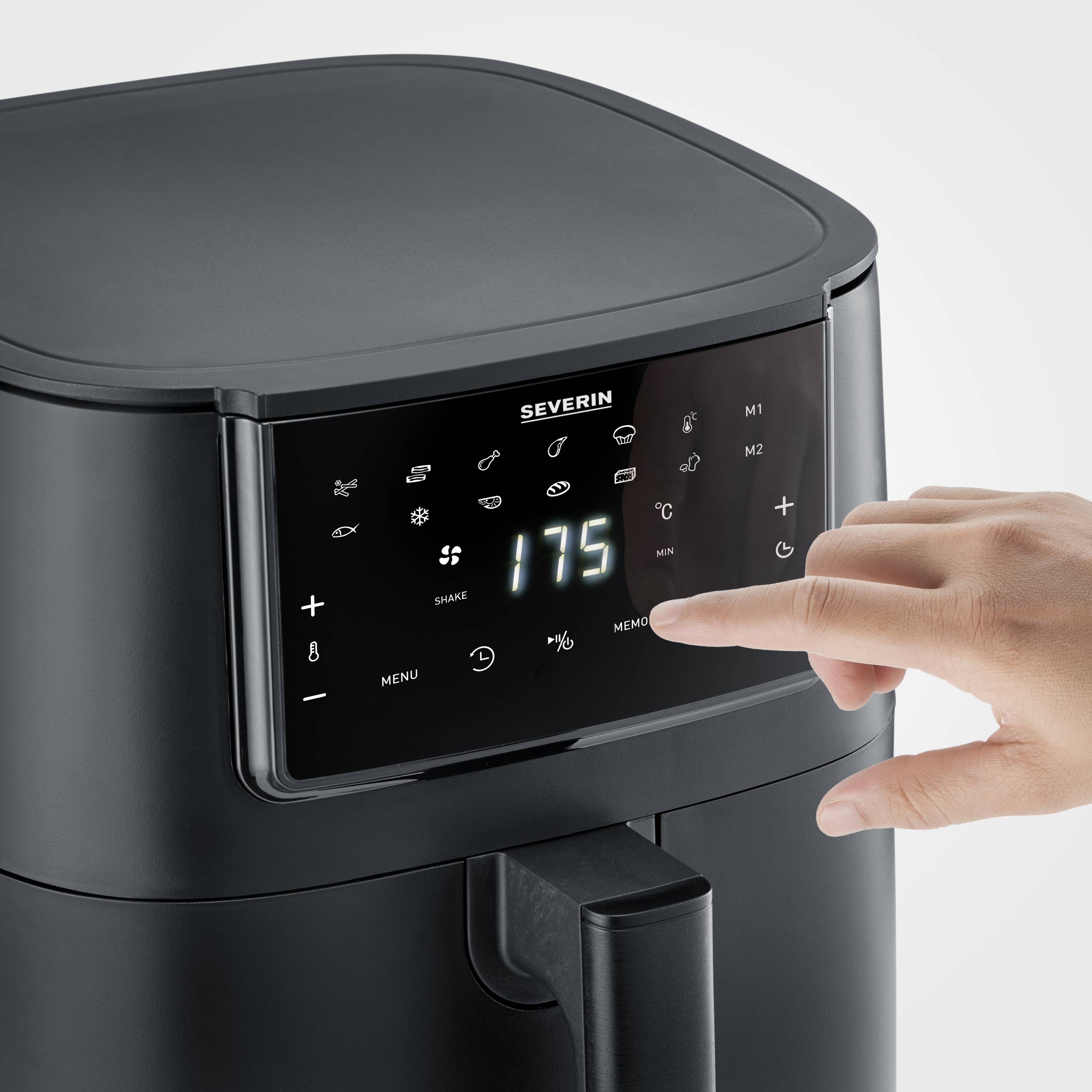 A digital air fryer with a display panel shows '175' degrees Celsius. A hand touches the control buttons.