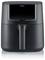 A black air fryer stands upright. It has a sleek, modern design with a handle in the centre.