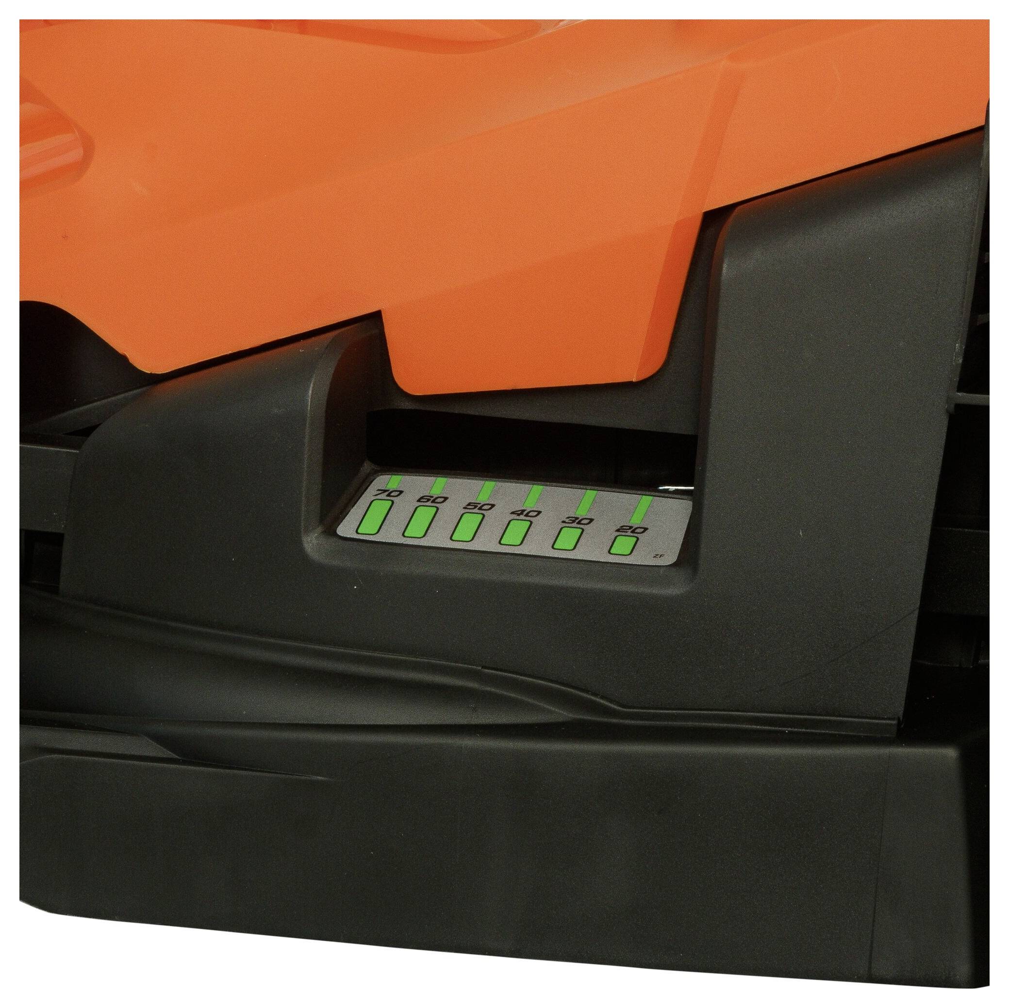 Close-up of a machine with a control panel. Several buttons are arranged in a row, identifiable by green markings.