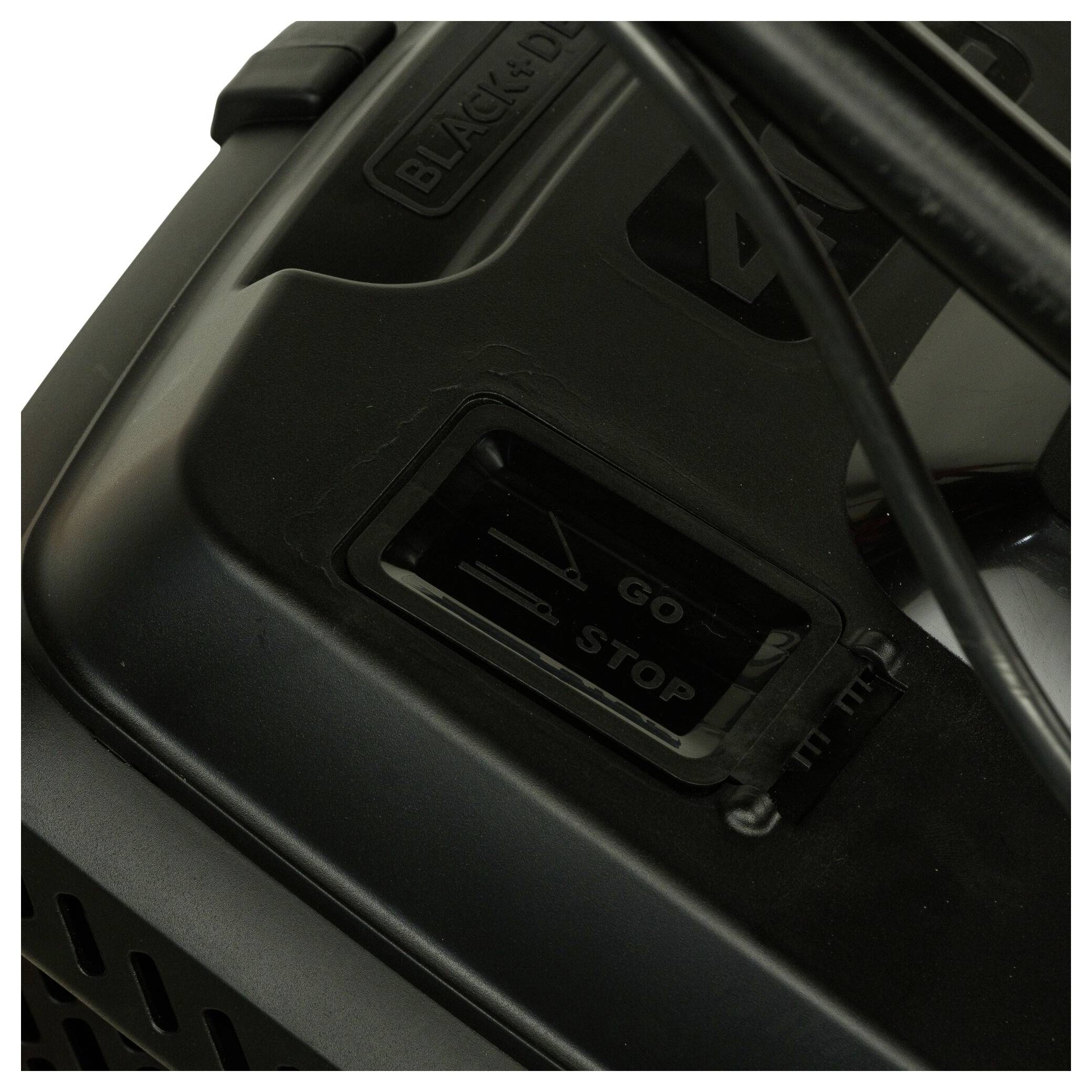 A close-up of a switch on a device with the options 'Go' and 'Stop'. A black cable is visible.