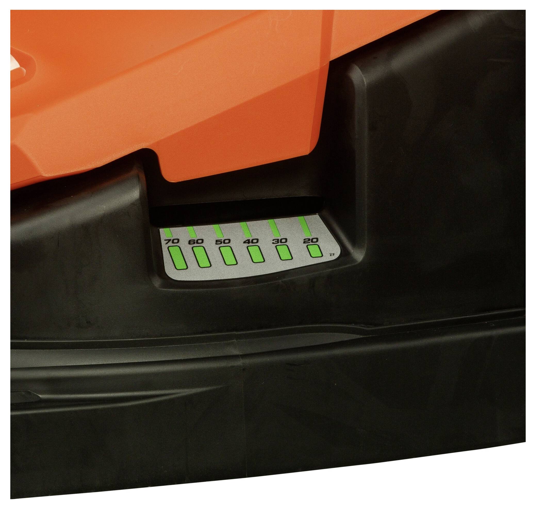 Close-up of an orange and black device with a green-illuminated display panel showing numbered ranges from 20 to 70.