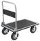 A flatbed trolley with four wheels and a silver handle, used for transporting goods. The platform has a black, textured surface.