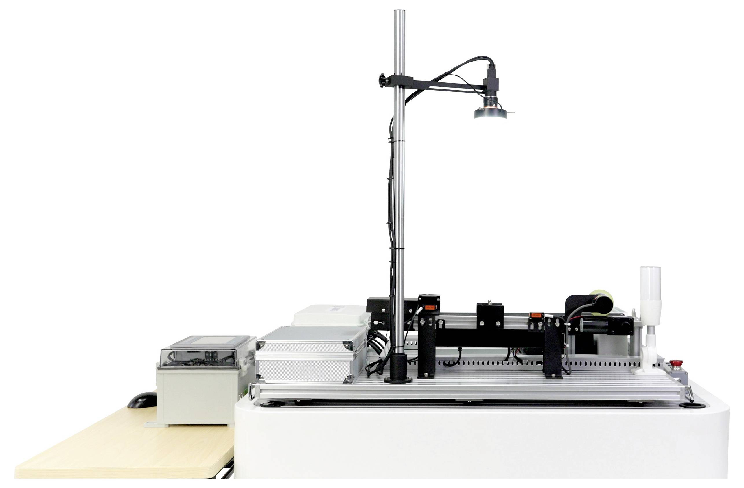 'A machine setup with a camera mounted above and electronic components on a flat surface, likely for automated inspection or assembly tasks.'