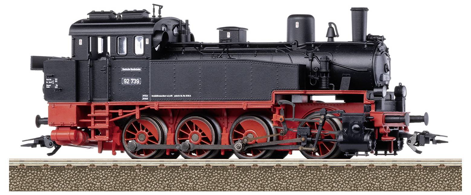 A black steam locomotive with a red undercarriage stands on a track. It has a distinctive chimney hood and large wheels.