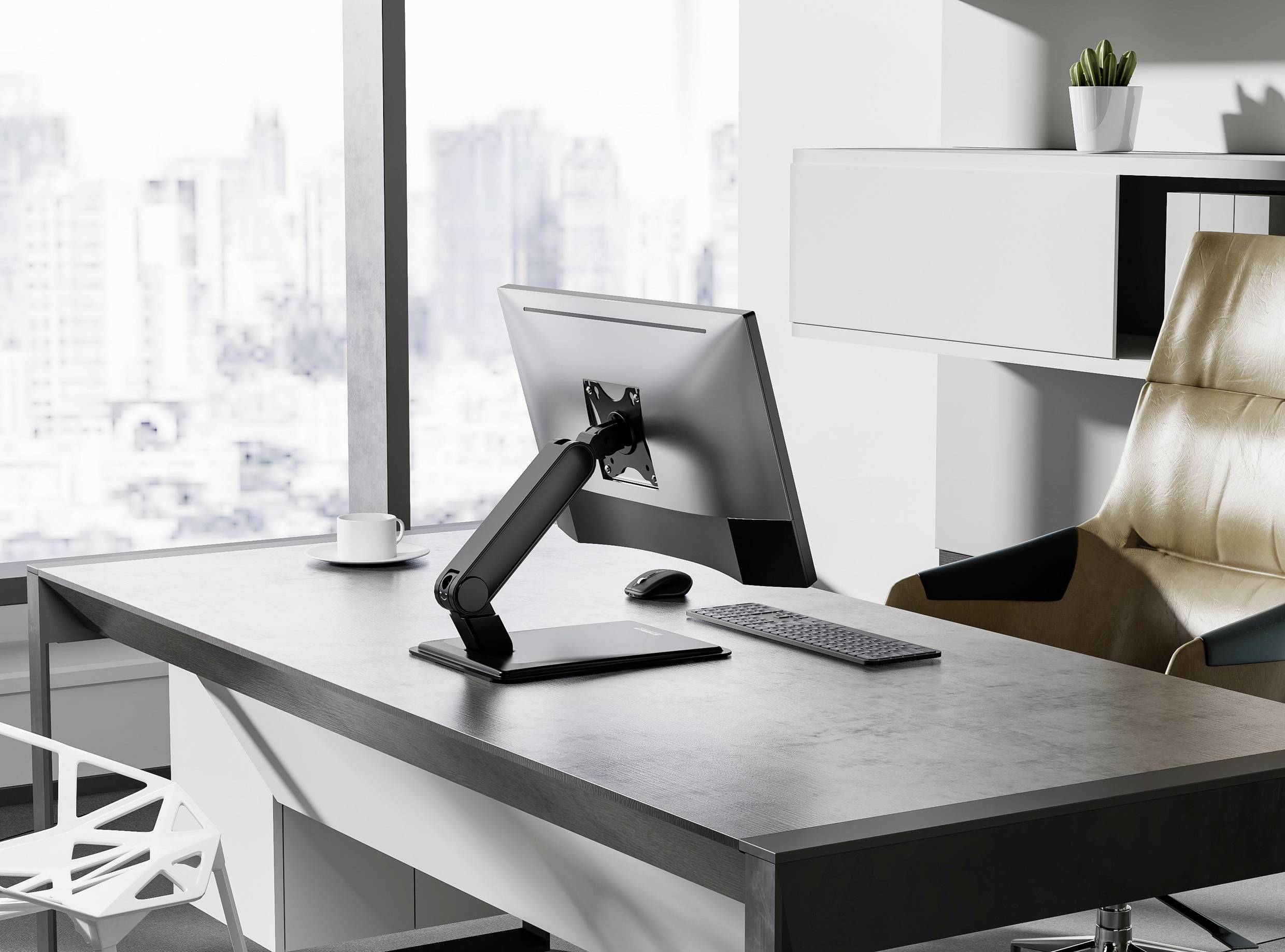 A modern office setup with a computer monitor on an adjustable stand, keyboard, and mouse on a clean desk, overlooking a cityscape.