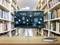 A monitor on a library desk displays digital icons, suggesting a theme of technology integration in learning. A book lies nearby.