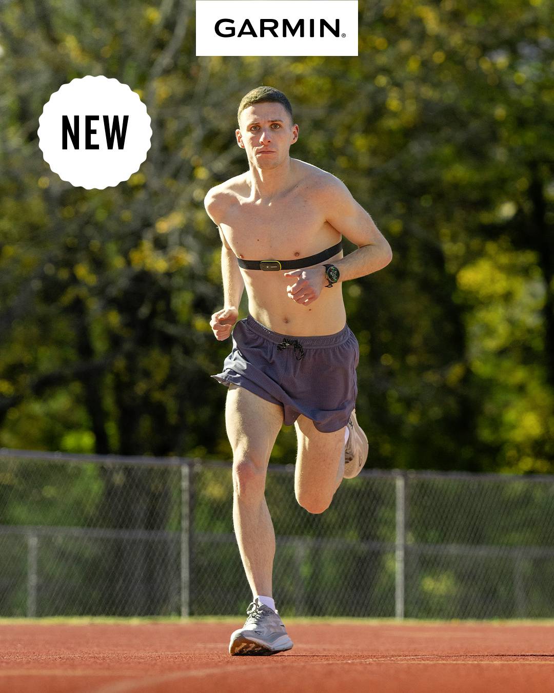A man is running on a track and wearing a fitness tracker. Trees in the background. At the top it says 'Garmin' and 'NEW'.