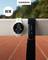 A Garmin smartwatch and a Garmin chest strap are placed on a railing in front of a running track. "NEW" appears in the top left.