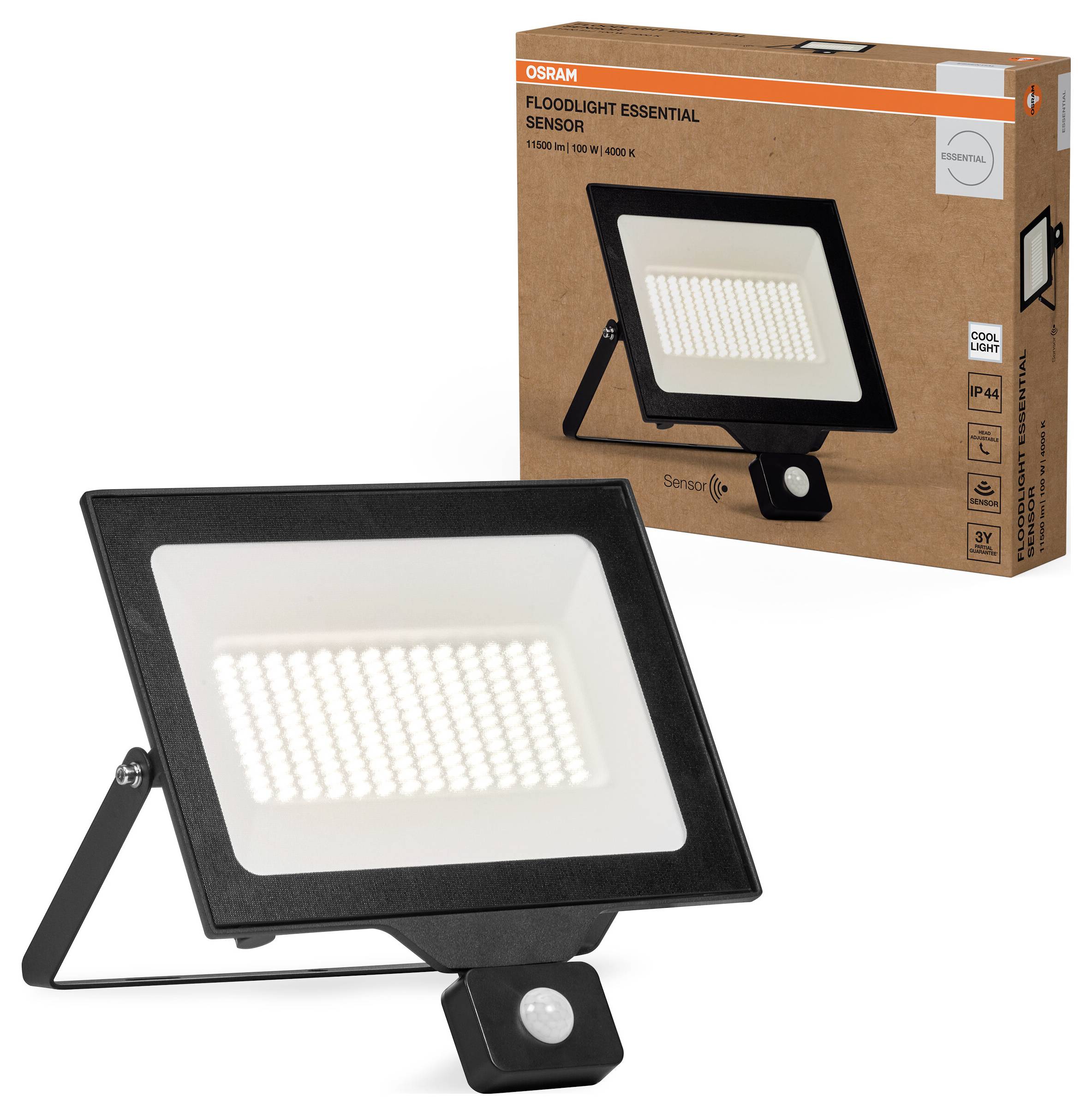 A floodlight with motion sensor, rectangular, black housing. Packaging in the background shows the product and the brand name.
