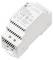 A white, box-shaped power supply unit with labeled connections for voltage and current. Includes specifications and certification marks.