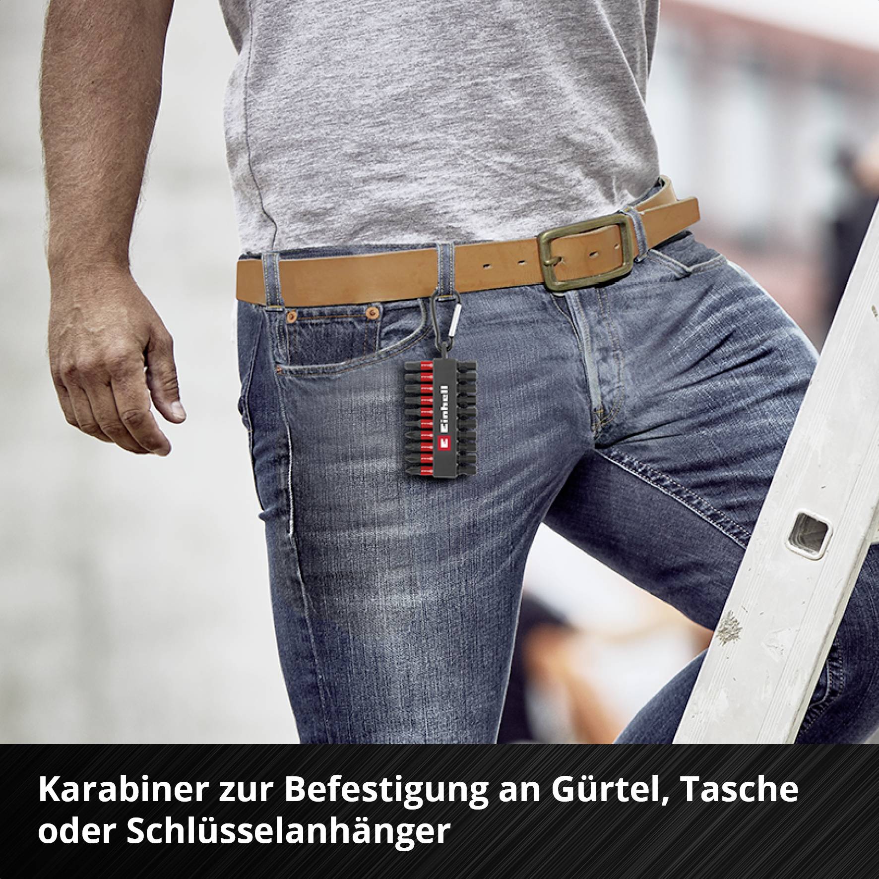 Man in jeans attaches a carabiner to his belt to hang a bag or keys. Text below: 'Carabiner for attachment to belt, bag or keychain'.
