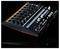 A black DJ mixer with buttons and knobs on a dark background, illuminated by colorful LED lights.