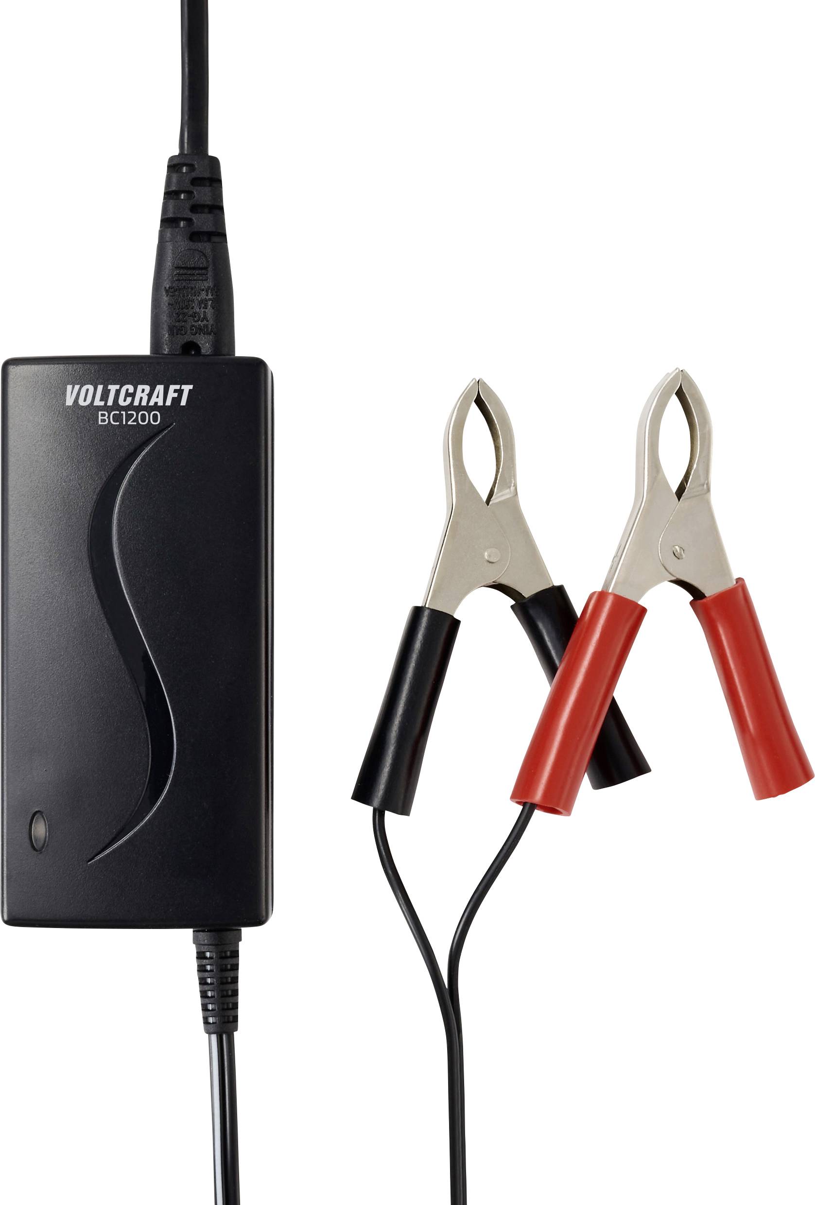 A black battery charger labeled 'Voltcraft BC1200' with attached red and black alligator clamps on wires, indicating charging functionality.