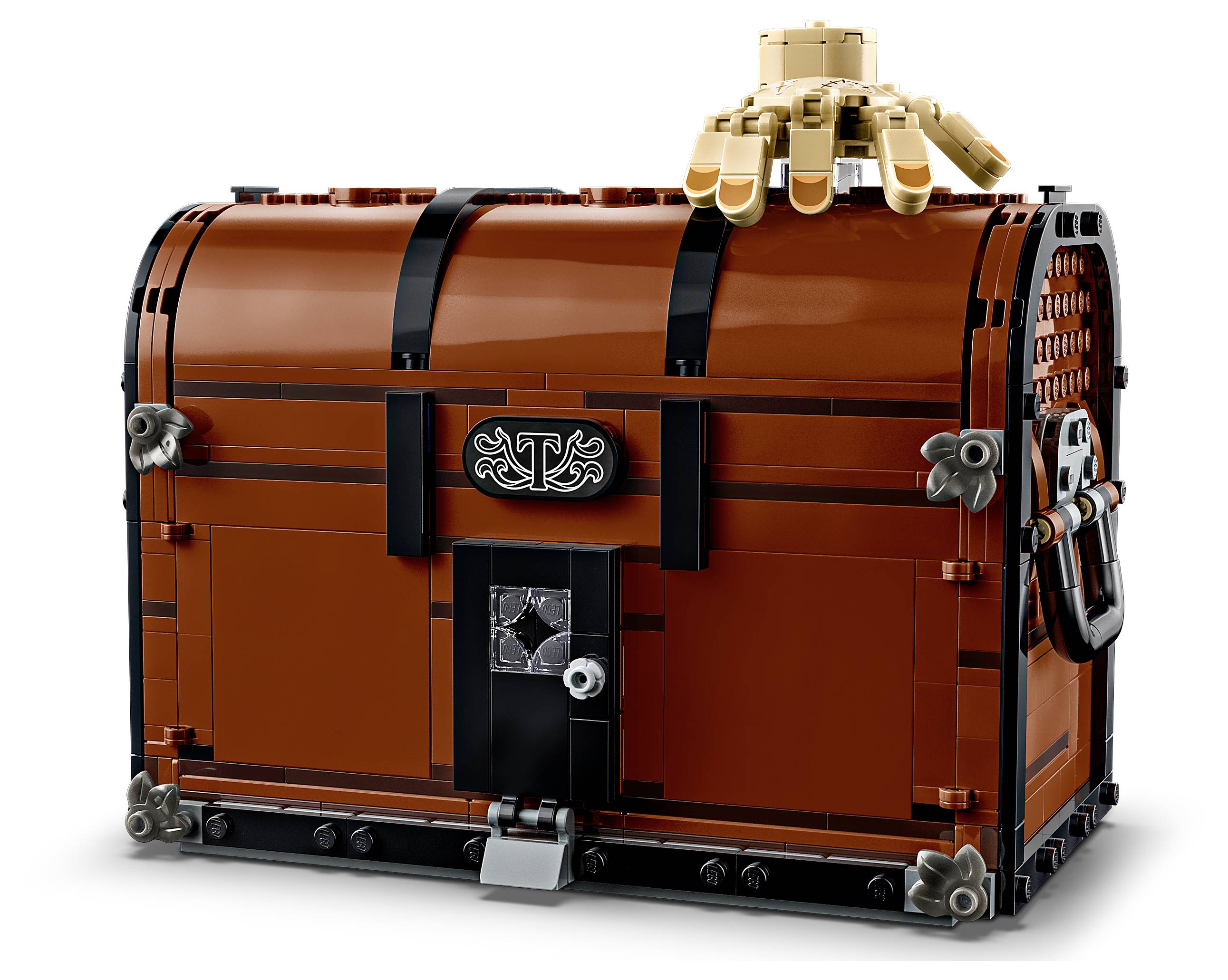 A brown LEGO treasure chest with decorative details, featuring a lock at the front and a golden LEGO hand on top, set against a plain background.