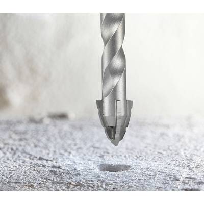 A drill bit poised above a concrete surface, highlighting precision in drilling tasks.
