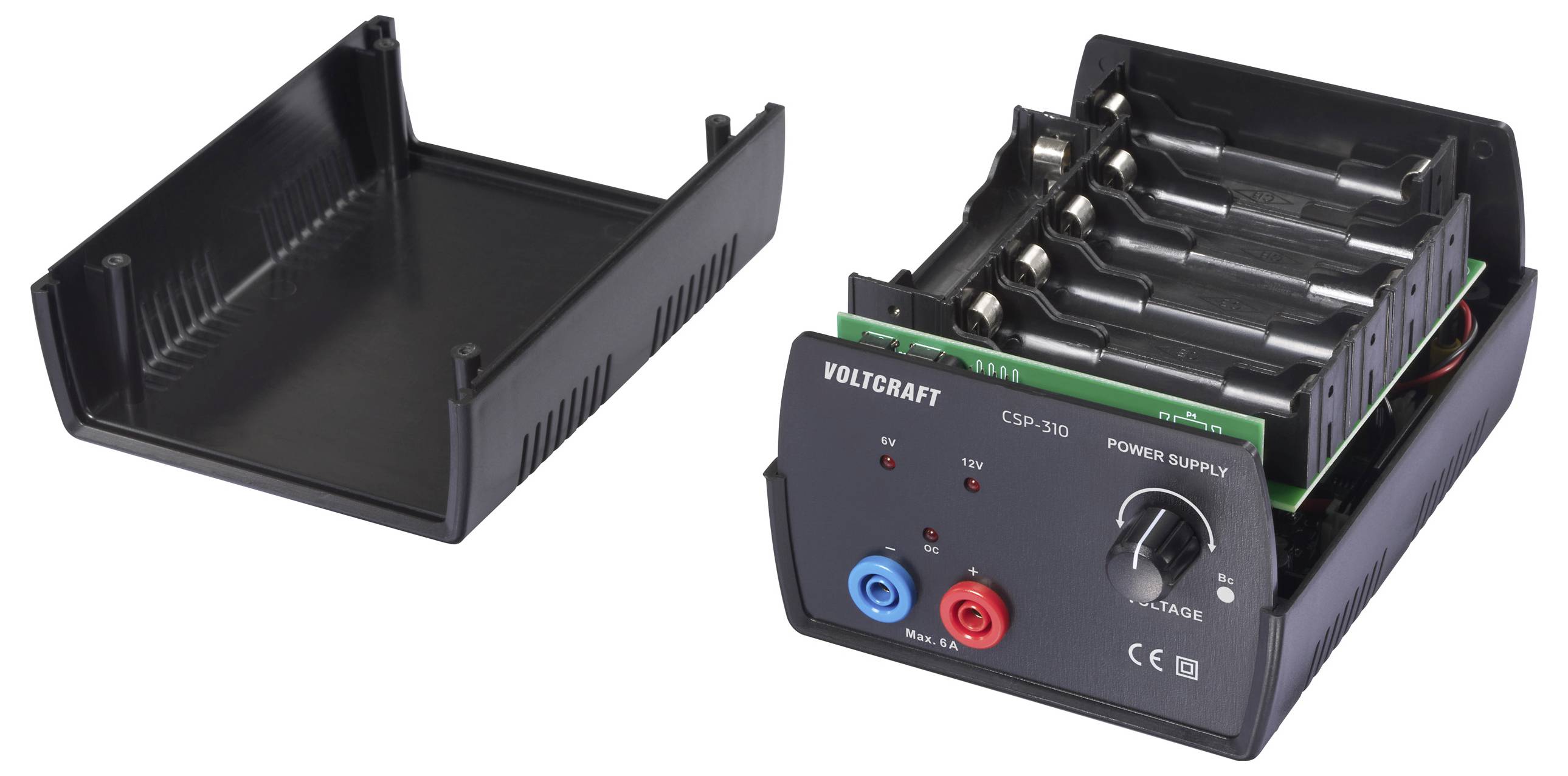 'A Voltcraft CSP-310 power supply with an open plastic casing showing multiple battery slots, power knob, and red and blue terminals.'