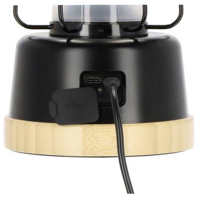 Close-up of a black and bamboo lantern base with a charging port and power cable plugged in.