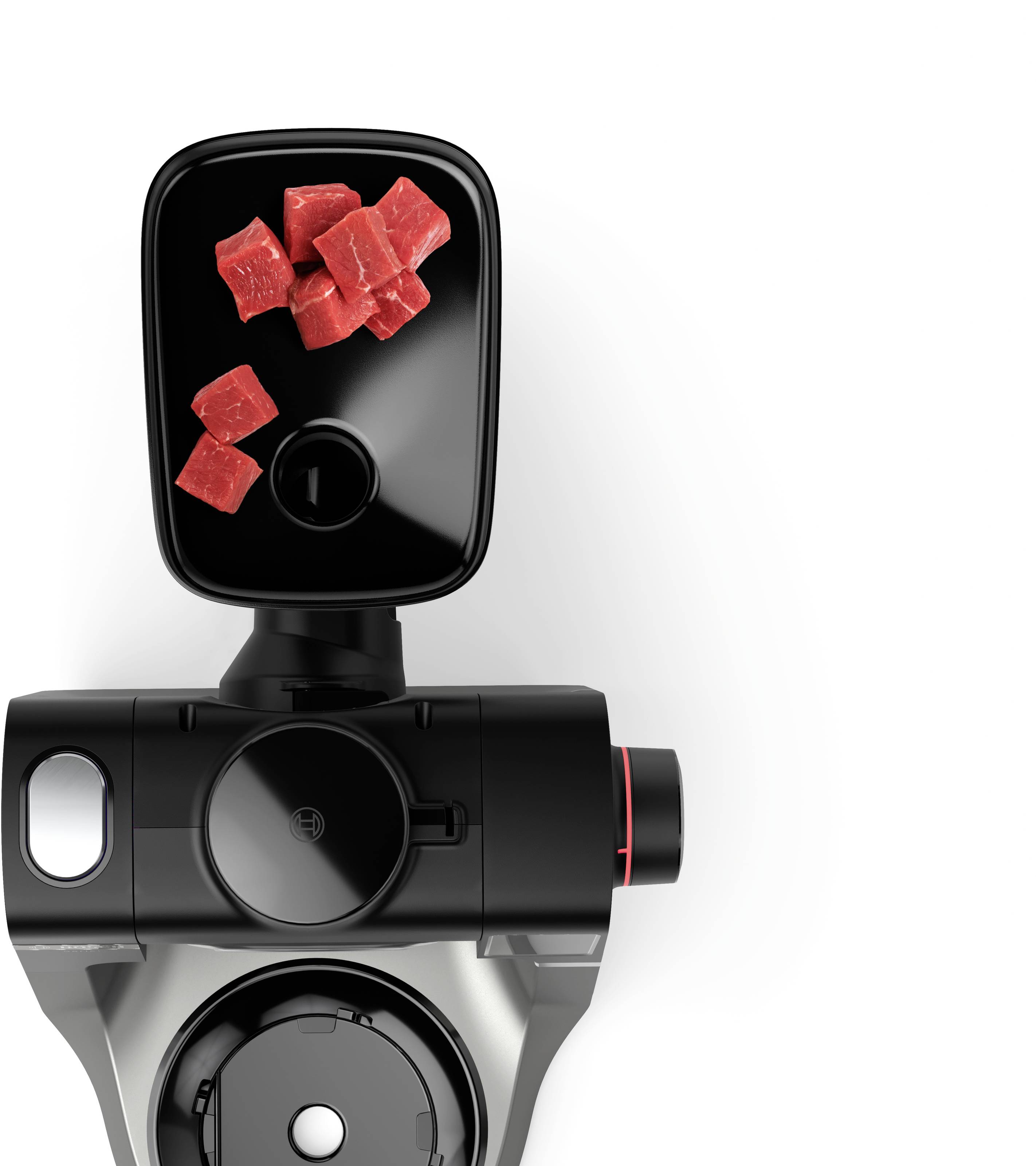 Kitchen appliance with small red cubes inside a black compartment, possibly indicating a function related to food preparation or processing.