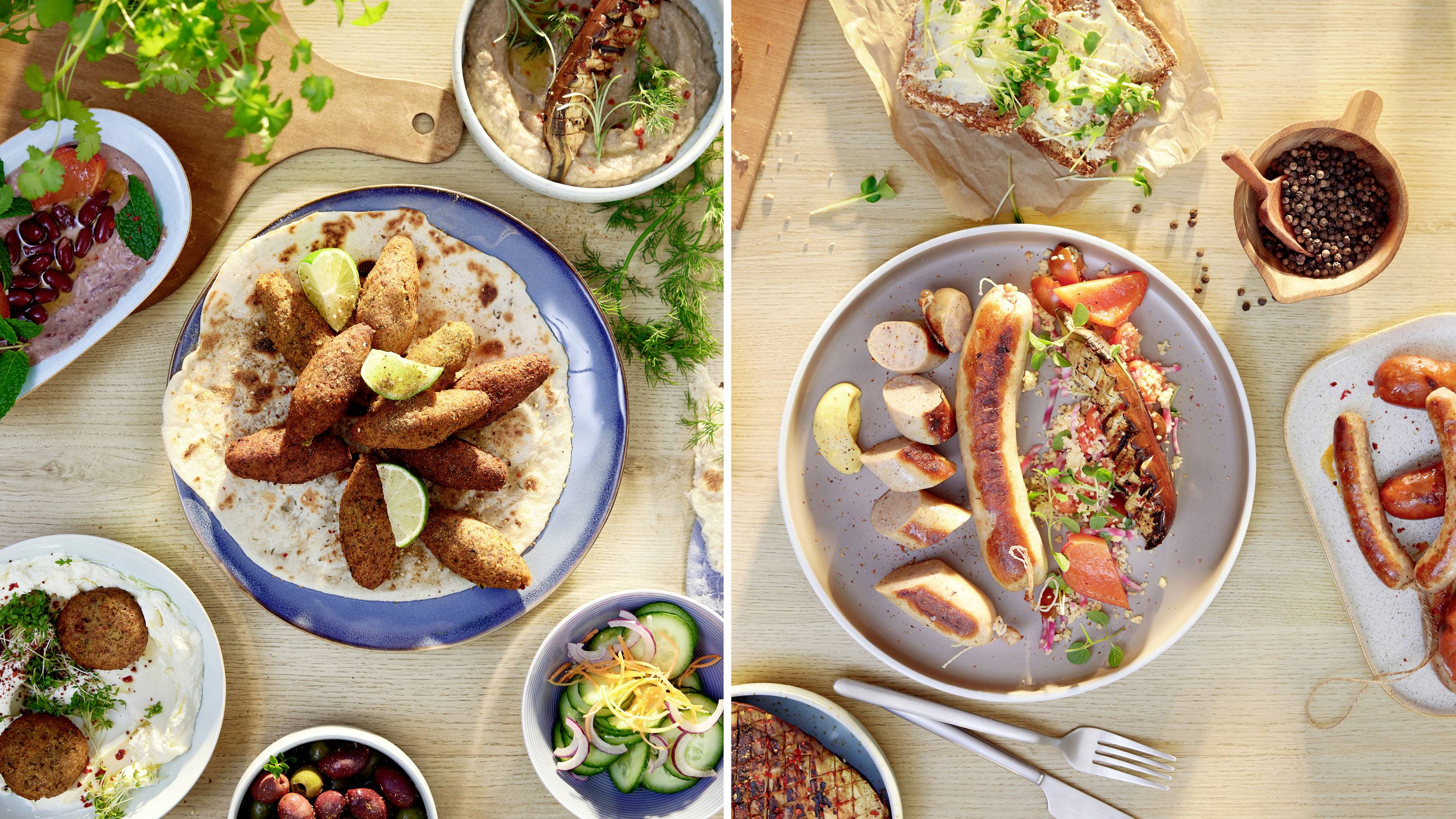 A table with various Mediterranean dishes including falafel on flatbread with lime, sliced sausages with toppings, and fresh salads.