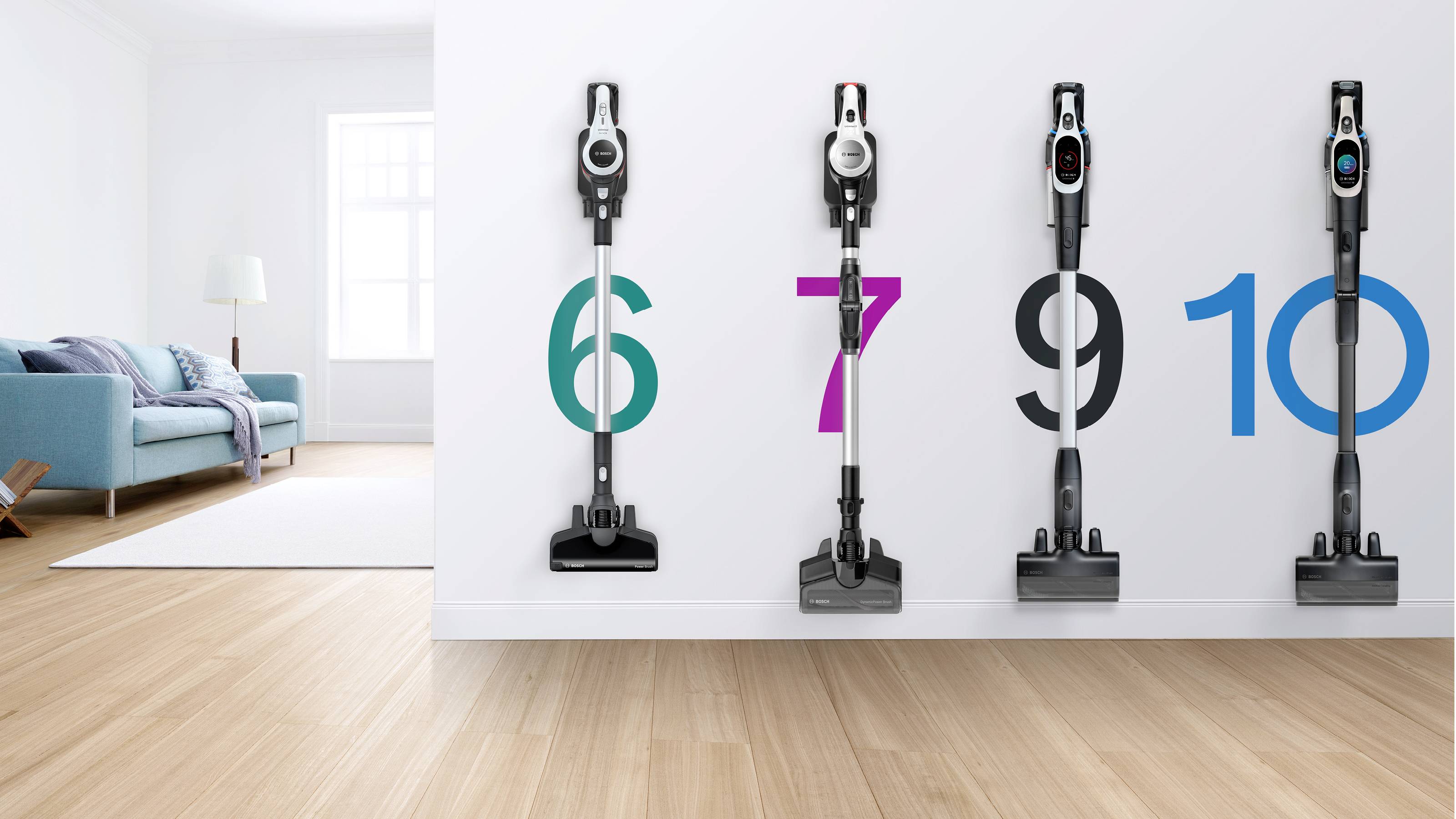 Four upright vacuum cleaners are mounted on a white wall, numbered 6, 7, 9, and 10 in different colors. A modern living room is visible.