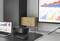 A modern office setup with a laptop and projector displaying colorful bar and line graphs on a screen, depicting financial data trends.