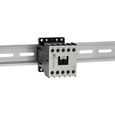 A white electrical contactor is mounted on a metal rail, featuring several labeled connection points, used to control electric circuits.