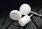 White polishing attachments on textured rubber surface, likely used for cleaning or smoothing.