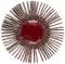 A red circular object with radiating, evenly spaced brown spokes resembling a stylized sunburst.
